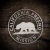 LDS California Fresno Mission Christmas Ornament laying on a Wooden Background