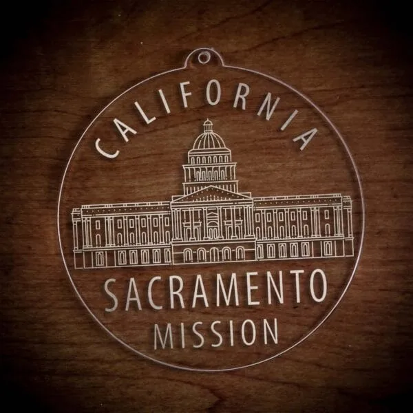 LDS California Sacramento Mission Christmas Ornament laying on a Wooden Background