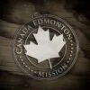 LDS Canada Edmonton Mission Christmas Ornament laying on a Wooden Background