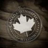 LDS Canada Winnipeg Mission Christmas Ornament laying on a Wooden Background