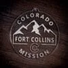 LDS Colorado Fort Collins Mission Christmas Ornament laying on a Wooden Background