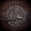 LDS Florida Tallahassee Mission Christmas Ornament laying on a Wooden Background