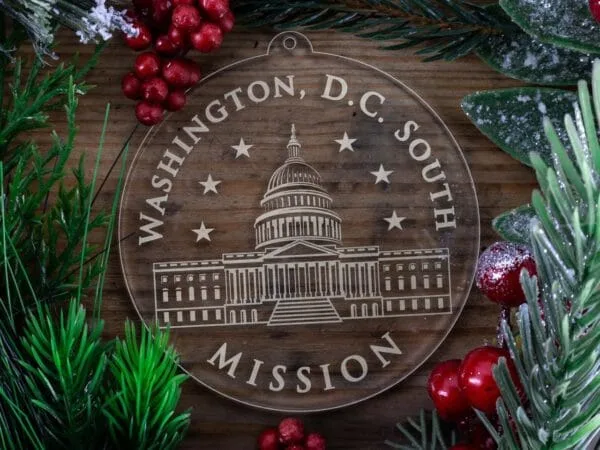 D.C. South Mission Christmas Ornament laying on a Wooden Background