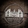 LDS England Birmingham Mission Christmas Ornament laying on a Wooden Background