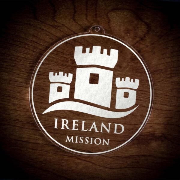 LDS Ireland Mission Christmas Ornament laying on a Wooden Background