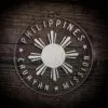 LDS Philippines Cauayan Mission Christmas Ornament laying on a Wooden Background
