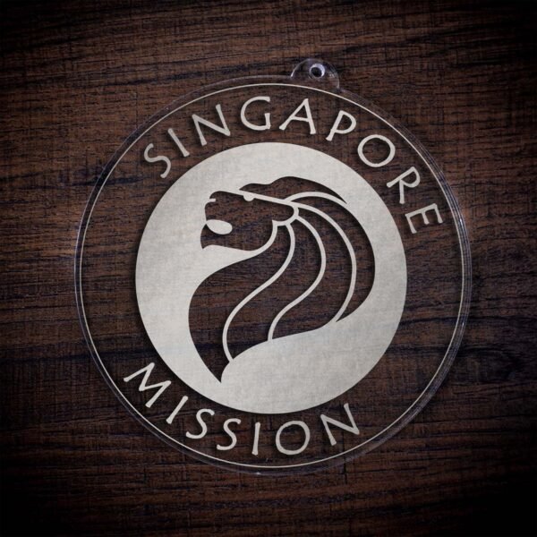 LDS Singapore Mission Christmas Ornament laying on a Wooden Background
