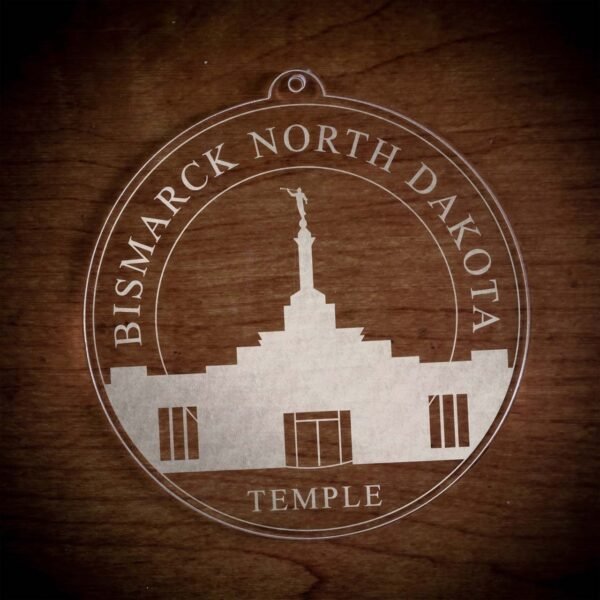 LDS Bismarck North Dakota Temple Christmas Ornament laying on a Wooden Background