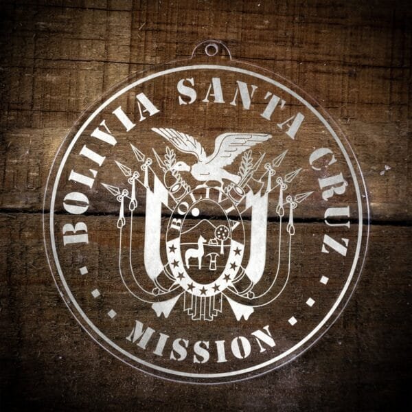 LDS Bolivia Santa Cruz Mission Christmas Ornament laying on a Wooden Background