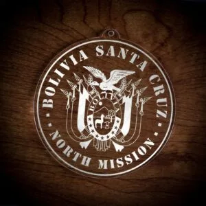 LDS Bolivia Santa Cruz North Mission Christmas Ornament laying on a Wooden Background