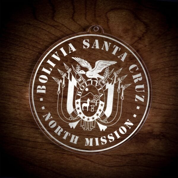 LDS Bolivia Santa Cruz North Mission Christmas Ornament laying on a Wooden Background