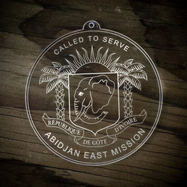 LDS Cote d'Ivoire Abidjan East Mission Christmas Ornament laying on a Wooden Background