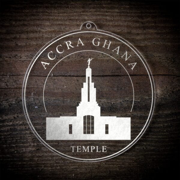 LDS Accra Ghana Temple Christmas Ornament laying on a Wooden Background