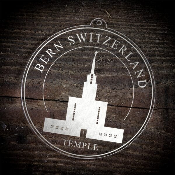 LDS Bern Switzerland Temple Christmas Ornament laying on a Wooden Background