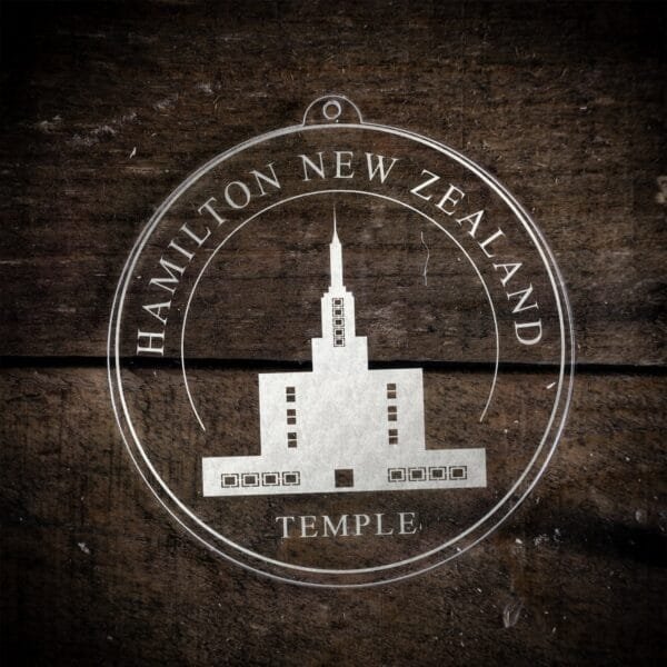 LDS Hamilton New Zealand Temple Christmas Ornament laying on a Wooden Background