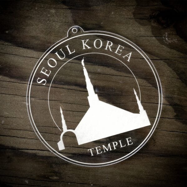 LDS Seoul Korea Temple Christmas Ornament laying on a Wooden Background