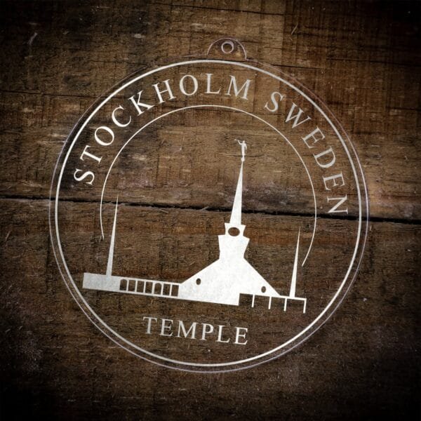 LDS Stockholm Sweden Temple Christmas Ornament laying on a Wooden Background