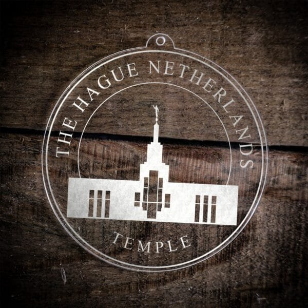 LDS The Hague Netherlands Temple Christmas Ornament laying on a Wooden Background